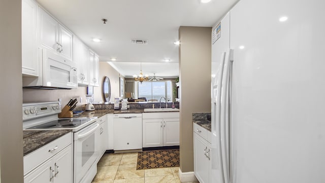 6415 Thomas Dr Unit 1205, Panama City Beach, FL 32408 - kitchen with white appliances, white cabinets, a chandelier, recessed lighting, and dark stone countertops