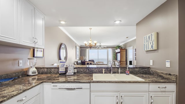 6415 Thomas Dr Unit 1205, Panama City Beach, FL 32408 - kitchen featuring white dishwasher, white cabinetry, crown molding, a chandelier, and dark stone countertops