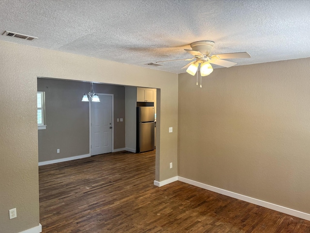 5148 Cavalier Dr, Crestview, FL 32539 - unfurnished room featuring dark wood-type flooring, a textured ceiling, ceiling fan, and a textured wall