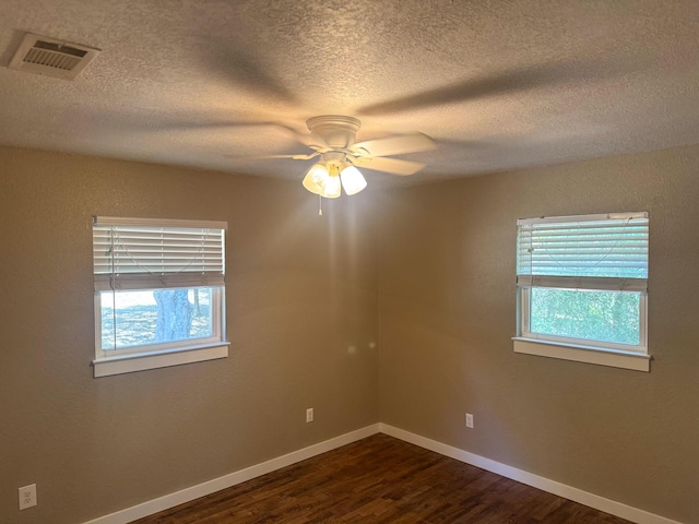 5148 Cavalier Dr, Crestview, FL 32539 - empty room featuring dark wood finished floors, a textured ceiling, and a ceiling fan
