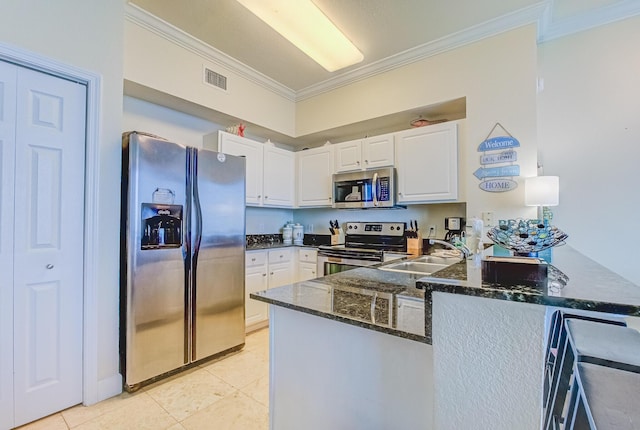 16819 Front Beach Rd Unit 2910, Panama City Beach, FL 32413 - kitchen featuring appliances with stainless steel finishes, crown molding, a peninsula, dark stone counters, and white cabinetry