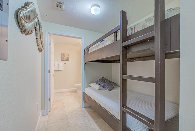 16819 Front Beach Rd Unit 2910, Panama City Beach, FL 32413 - bedroom with baseboards and connected bathroom