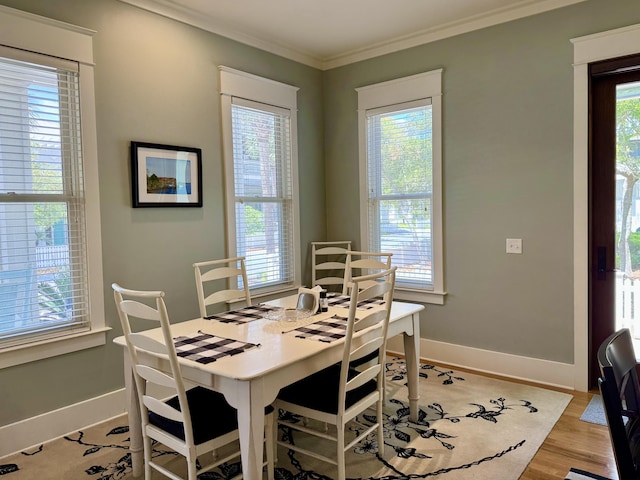 209 Dune Crest Ln, Panama City Beach, FL 32413 - dining area featuring plenty of natural light, ornamental molding, and light wood-type flooring