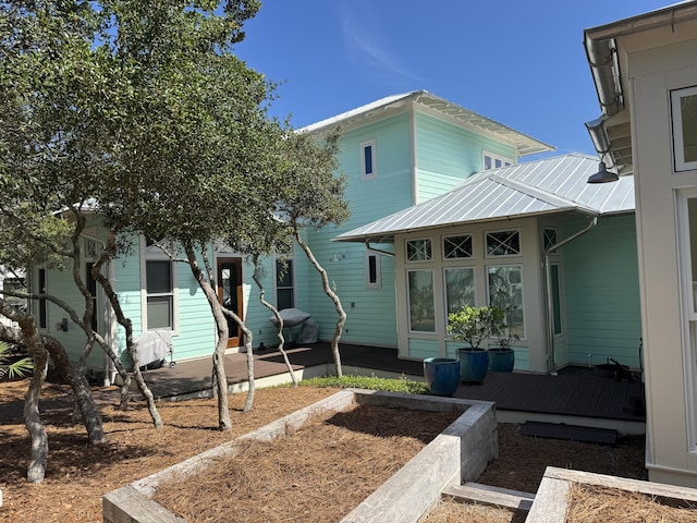 209 Dune Crest Ln, Panama City Beach, FL 32413 - view of front of house featuring a metal roof, a deck, and a patio area