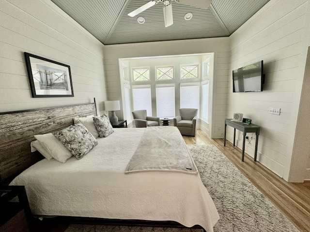 209 Dune Crest Ln, Panama City Beach, FL 32413 - bedroom with vaulted ceiling, wood finished floors, and wooden walls
