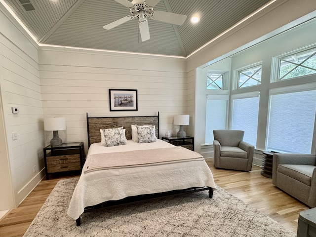209 Dune Crest Ln, Panama City Beach, FL 32413 - bedroom featuring light wood-style floors, high vaulted ceiling, wood walls, a ceiling fan, and recessed lighting