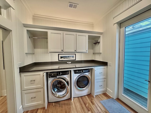 209 Dune Crest Ln, Panama City Beach, FL 32413 - washroom with cabinet space, washer and clothes dryer, light wood-type flooring, and ornamental molding
