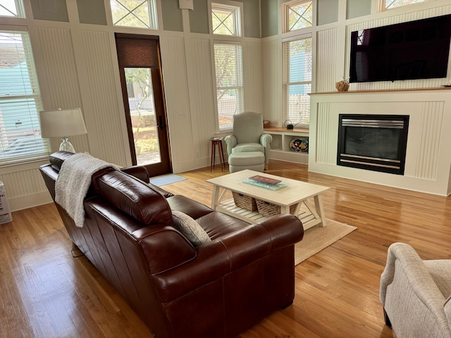 209 Dune Crest Ln, Panama City Beach, FL 32413 - living room featuring wood finished floors, a glass covered fireplace, and healthy amount of natural light