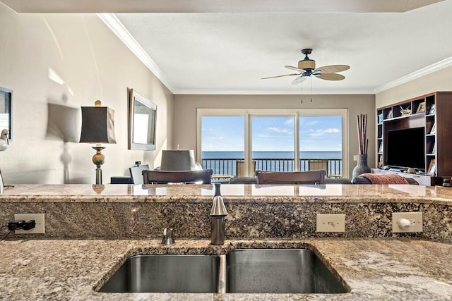 6323 Thomas Dr Unit 904B, Panama City Beach, FL 32408 - kitchen with ceiling fan, stone counters, and crown molding