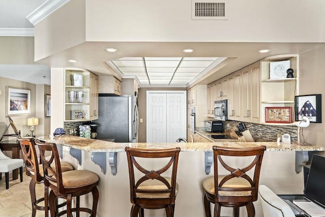6323 Thomas Dr Unit 904B, Panama City Beach, FL 32408 - kitchen featuring appliances with stainless steel finishes, open shelves, ornamental molding, tasteful backsplash, and a peninsula