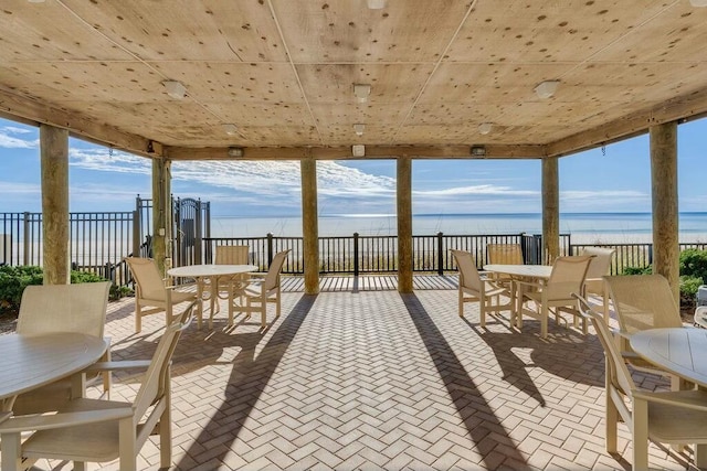6323 Thomas Dr Unit 904B, Panama City Beach, FL 32408 - view of patio with outdoor dining space and view of water and beach