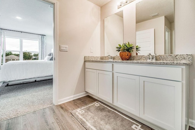 739 Quintana St, Crestview, FL 32539 - bathroom with ensuite bathroom, double vanity, and wood finished floors