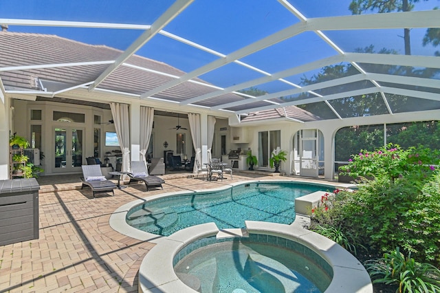 4564 Nautical Ct, Destin, FL 32541 - view of swimming pool with french doors, a patio area, a pool with connected hot tub, a ceiling fan, and glass enclosure