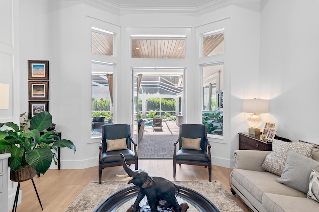 4564 Nautical Ct, Destin, FL 32541 - living area with wood finished floors, a sunroom, and ornamental molding