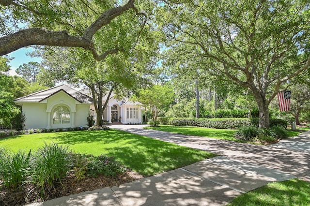 4564 Nautical Ct, Destin, FL 32541 - view of front of property featuring a front yard and stucco siding