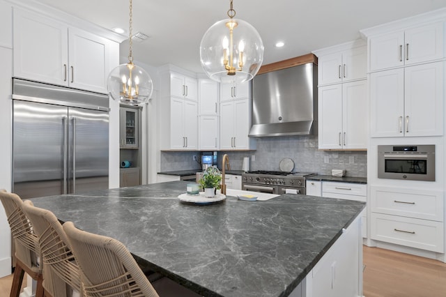 4564 Nautical Ct, Destin, FL 32541 - kitchen with a chandelier, high quality appliances, backsplash, white cabinetry, and recessed lighting