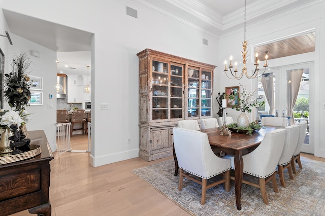 4564 Nautical Ct, Destin, FL 32541 - dining room with light wood-type flooring, a chandelier, and crown molding