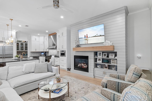 4564 Nautical Ct, Destin, FL 32541 - living area featuring recessed lighting, a ceiling fan, light wood-style flooring, a fireplace, and crown molding