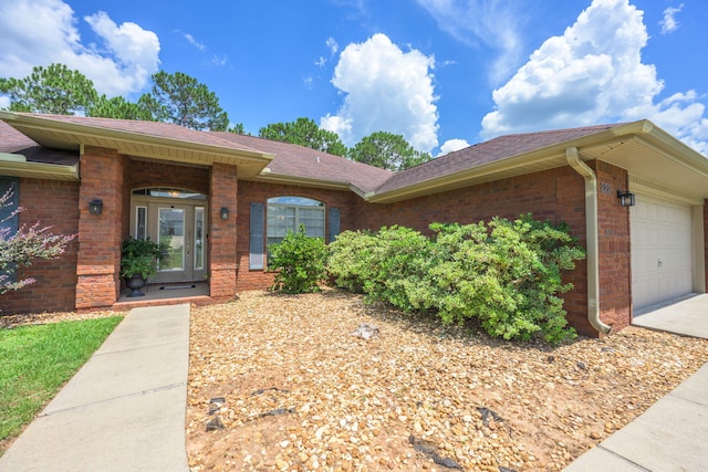 222 Raptor Dr, Crestview, FL 32536 - view of front of house featuring brick siding, an attached garage, and roof with shingles