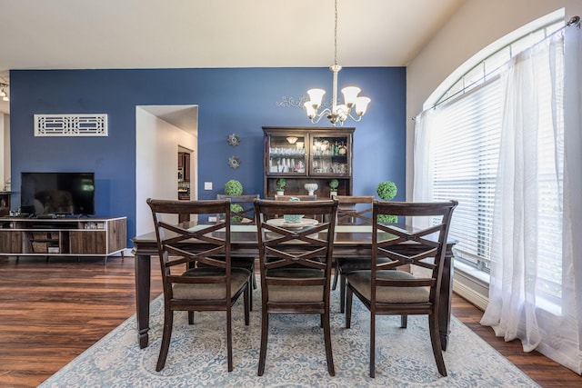 222 Raptor Dr, Crestview, FL 32536 - dining area featuring a chandelier, wood finished floors, and healthy amount of natural light