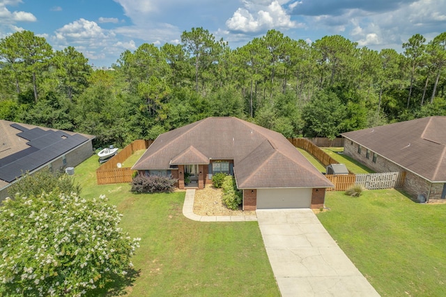 222 Raptor Dr, Crestview, FL 32536 - view of front of house with a garage, driveway, a fenced backyard, and brick siding