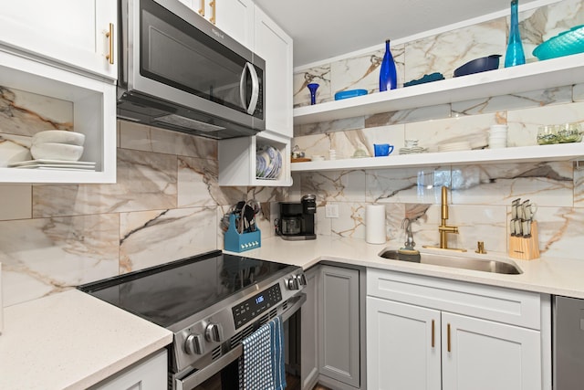 210 Pelham Rd Unit 211B, Fort Walton Beach, FL 32547 - kitchen with appliances with stainless steel finishes, open shelves, decorative backsplash, and white cabinets