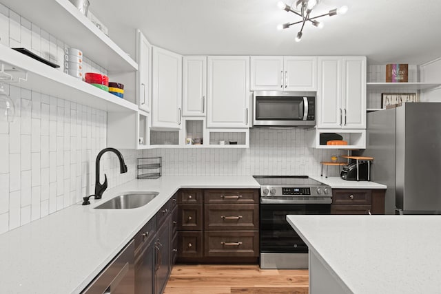 210 Pelham Rd Unit 210B, Fort Walton Beach, FL 32547 - kitchen featuring open shelves, stainless steel appliances, white cabinets, and dark brown cabinets