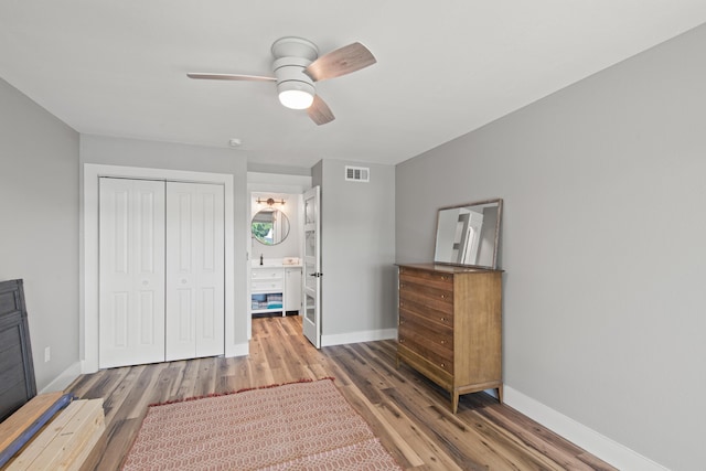 210 Pelham Rd Unit 210B, Fort Walton Beach, FL 32547 - unfurnished bedroom with wood finished floors, a closet, a ceiling fan, and ensuite bathroom