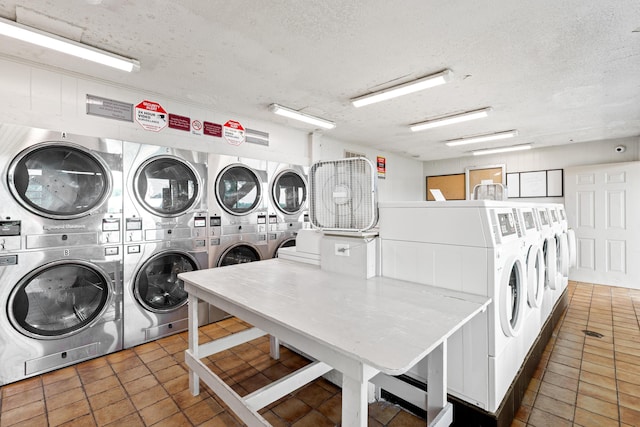 210 Pelham Rd Unit 210B, Fort Walton Beach, FL 32547 - communal laundry room featuring stacked washing machine and dryer, a textured ceiling, tile patterned floors, and washing machine and dryer