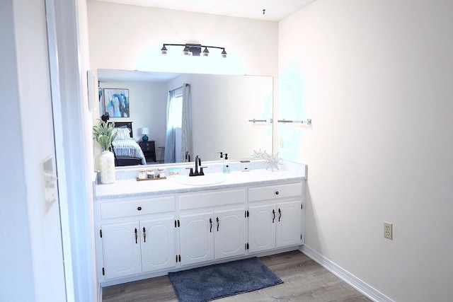 34 5th Ave Unit A, Shalimar, FL 32579 - bathroom with vanity, ensuite bath, and wood finished floors
