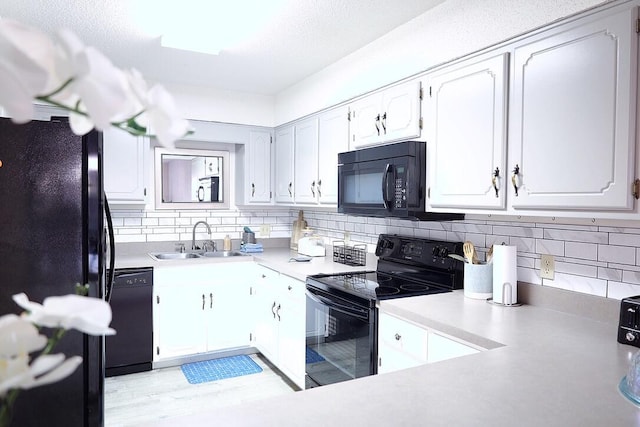 34 5th Ave Unit A, Shalimar, FL 32579 - kitchen featuring black appliances, tasteful backsplash, white cabinets, and light countertops