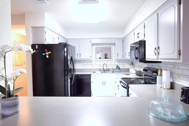 34 5th Ave Unit A, Shalimar, FL 32579 - kitchen featuring black appliances, tasteful backsplash, light countertops, white cabinets, and a textured ceiling