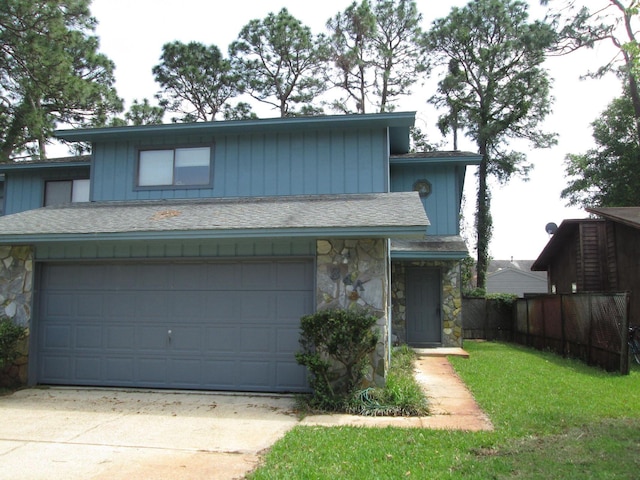 34 5th Ave Unit A, Shalimar, FL 32579 - view of front of house with stone siding, concrete driveway, a garage, and a shingled roof