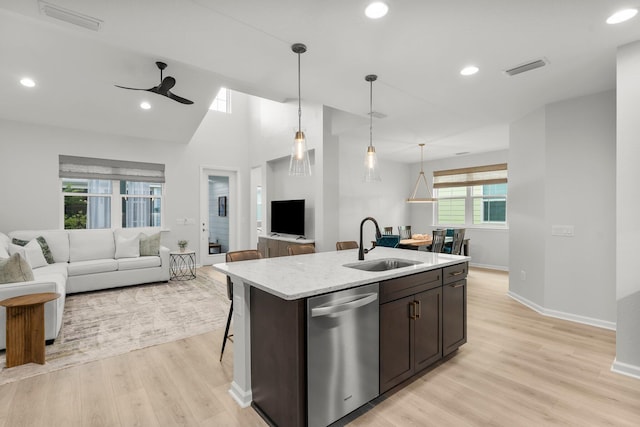 8450 Dreams Float Ct, Panama City Beach, FL 32413 - kitchen featuring stainless steel dishwasher, open floor plan, ceiling fan, dark brown cabinets, and light wood finished floors