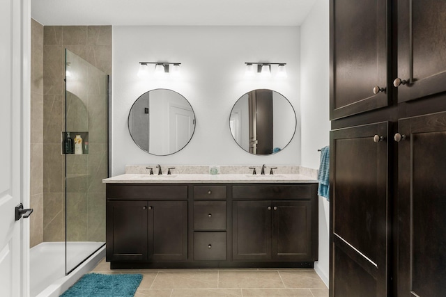 8450 Dreams Float Ct, Panama City Beach, FL 32413 - bathroom with double vanity, a tile shower, and tile patterned floors