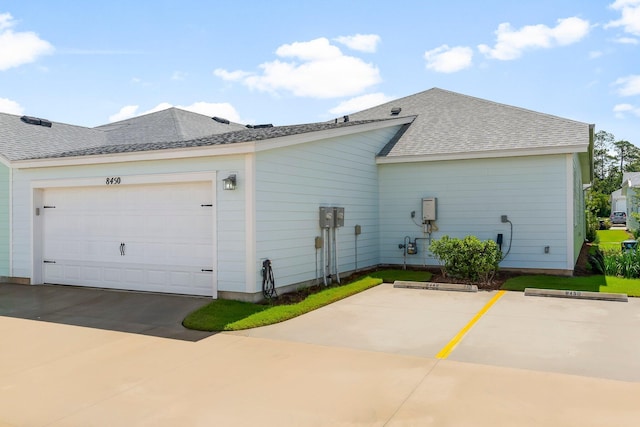 8450 Dreams Float Ct, Panama City Beach, FL 32413 - view of home's exterior with roof with shingles and a garage