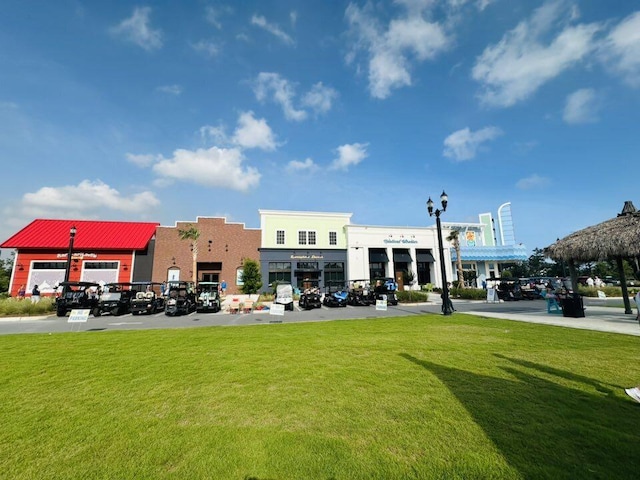 8450 Dreams Float Ct, Panama City Beach, FL 32413 - view of home's community with a lawn and uncovered parking