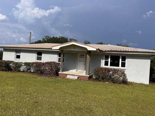 2032 Brogdon St, Grand Ridge, FL 32442 - ranch-style home with a front yard, covered porch, brick siding, and a metal roof