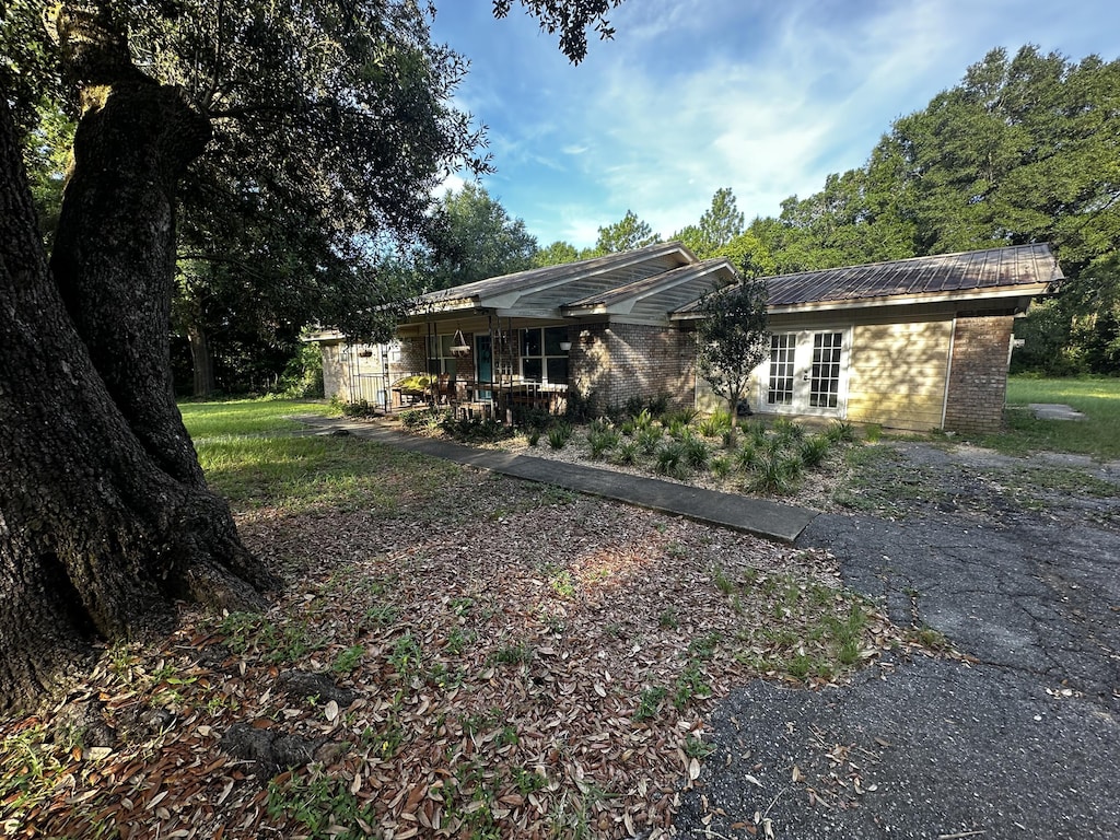 3174 Earl Kennedy Rd, Crestview, FL 32539 - back of property with brick siding and a metal roof