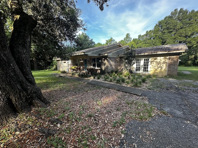 3174 Earl Kennedy Rd, Crestview, FL 32539 - back of property with brick siding and a metal roof