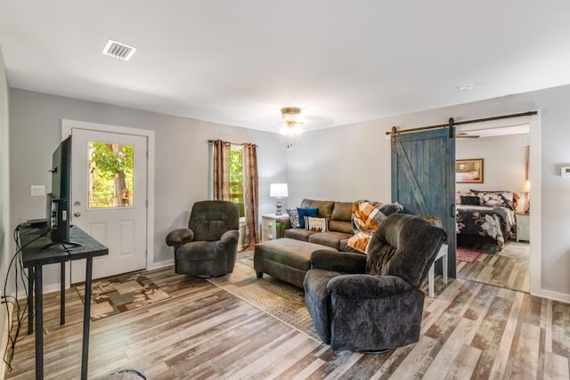 2141 C Shelby Ln, Westville, FL 32464 - living room with a barn door and light wood-style floors