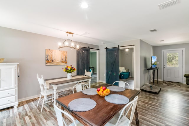 2141 C Shelby Ln, Westville, FL 32464 - dining room featuring a barn door and light wood-style flooring