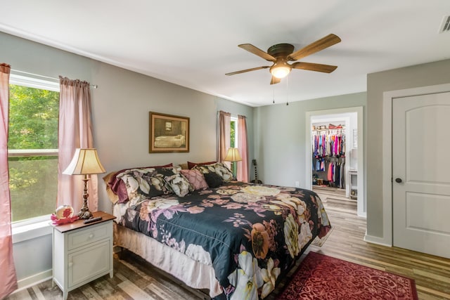 2141 C Shelby Ln, Westville, FL 32464 - bedroom with multiple windows, light wood-type flooring, a spacious closet, and ceiling fan