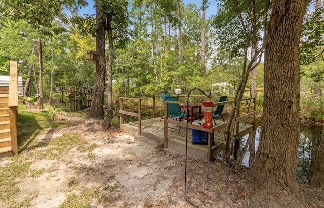 2141 C Shelby Ln, Westville, FL 32464 - view of play area featuring a deck and view of wooded area
