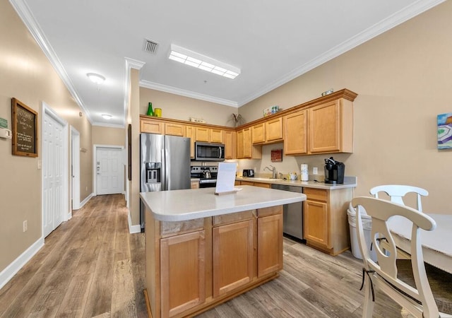 231 Somerset Bridge Rd Unit 2308, Santa Rosa Beach, FL 32459 - kitchen with a center island, light wood-style flooring, light countertops, stainless steel appliances, and crown molding