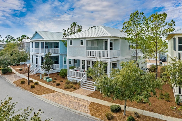 654 Flatwoods Forest Loop, Santa Rosa Beach, FL 32459 - view of front of house featuring a metal roof and a balcony