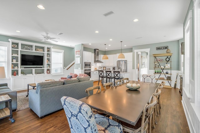 654 Flatwoods Forest Loop, Santa Rosa Beach, FL 32459 - dining space with ceiling fan, dark wood-type flooring, recessed lighting, wainscoting, and stairway