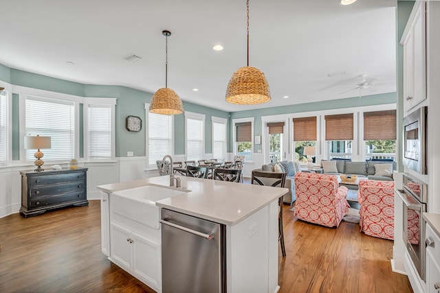 654 Flatwoods Forest Loop, Santa Rosa Beach, FL 32459 - kitchen featuring appliances with stainless steel finishes, wood finished floors, ceiling fan, a wainscoted wall, and light countertops