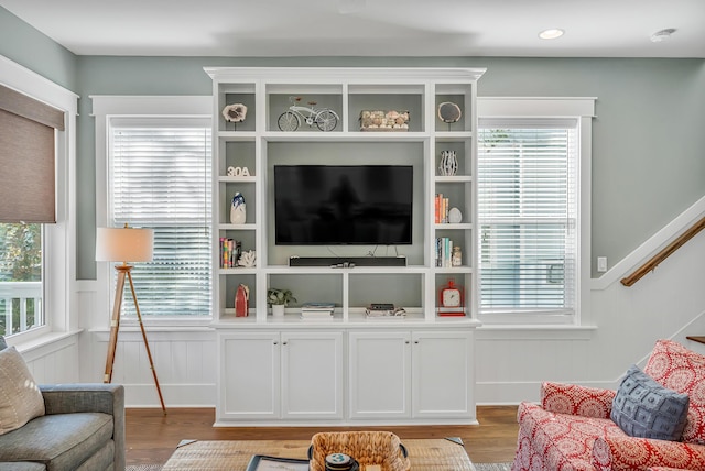 654 Flatwoods Forest Loop, Santa Rosa Beach, FL 32459 - living area featuring light wood-type flooring, plenty of natural light, stairway, and a wainscoted wall