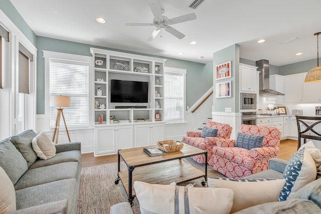 654 Flatwoods Forest Loop, Santa Rosa Beach, FL 32459 - living room featuring a wainscoted wall, ceiling fan, light wood-type flooring, recessed lighting, and stairway